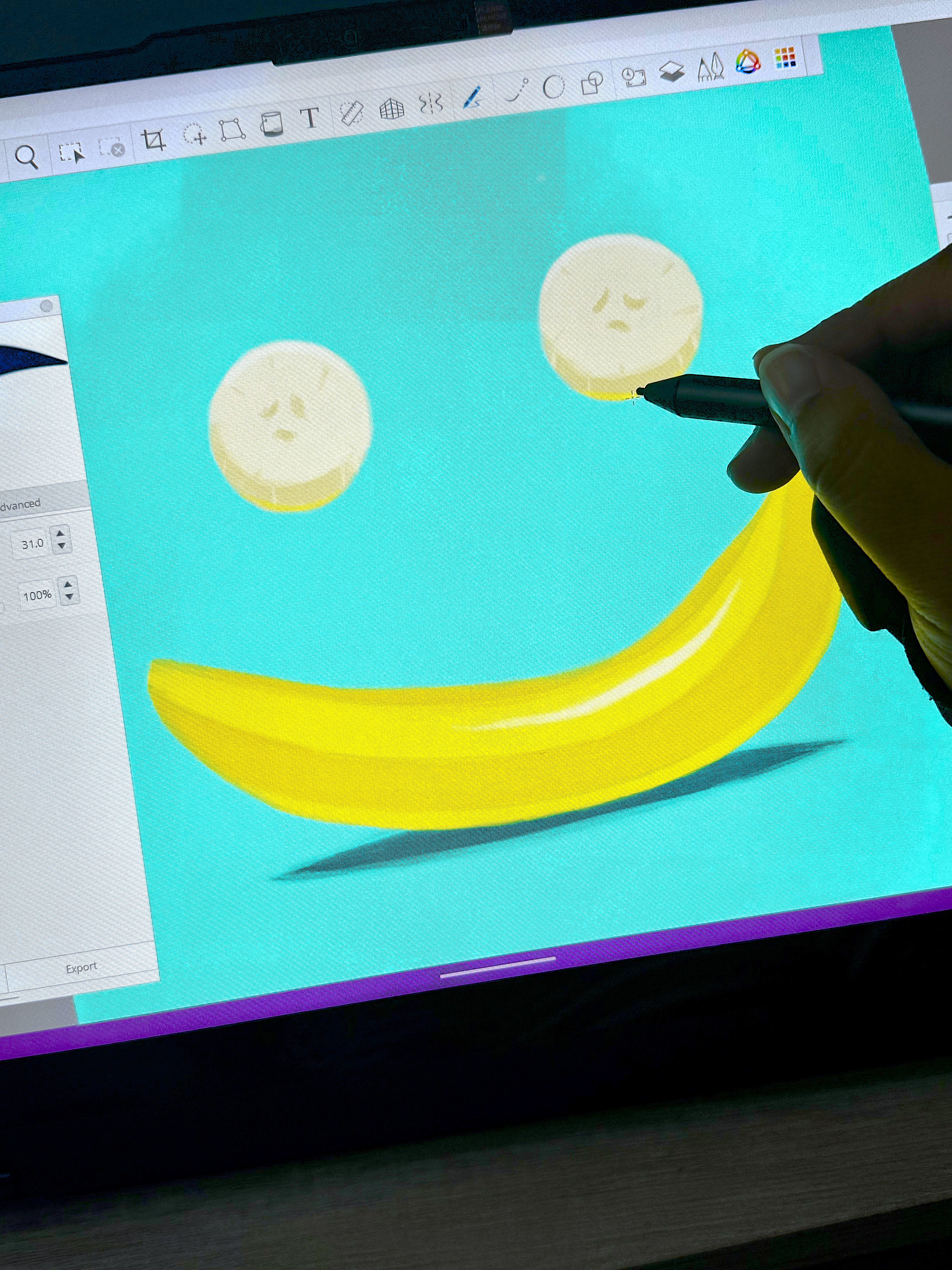 Hand holding a pen and drawing an illustration of bananas.